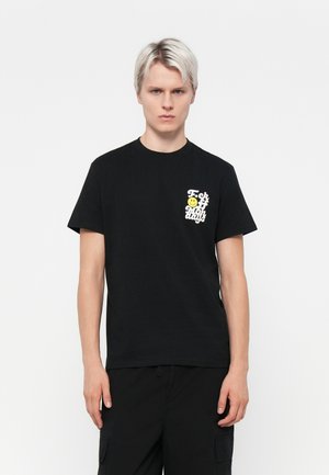 Black cotton t-shirt featuring a front pocket graphic with a yellow smiley face and text in white. Short sleeves and a crew neck design.