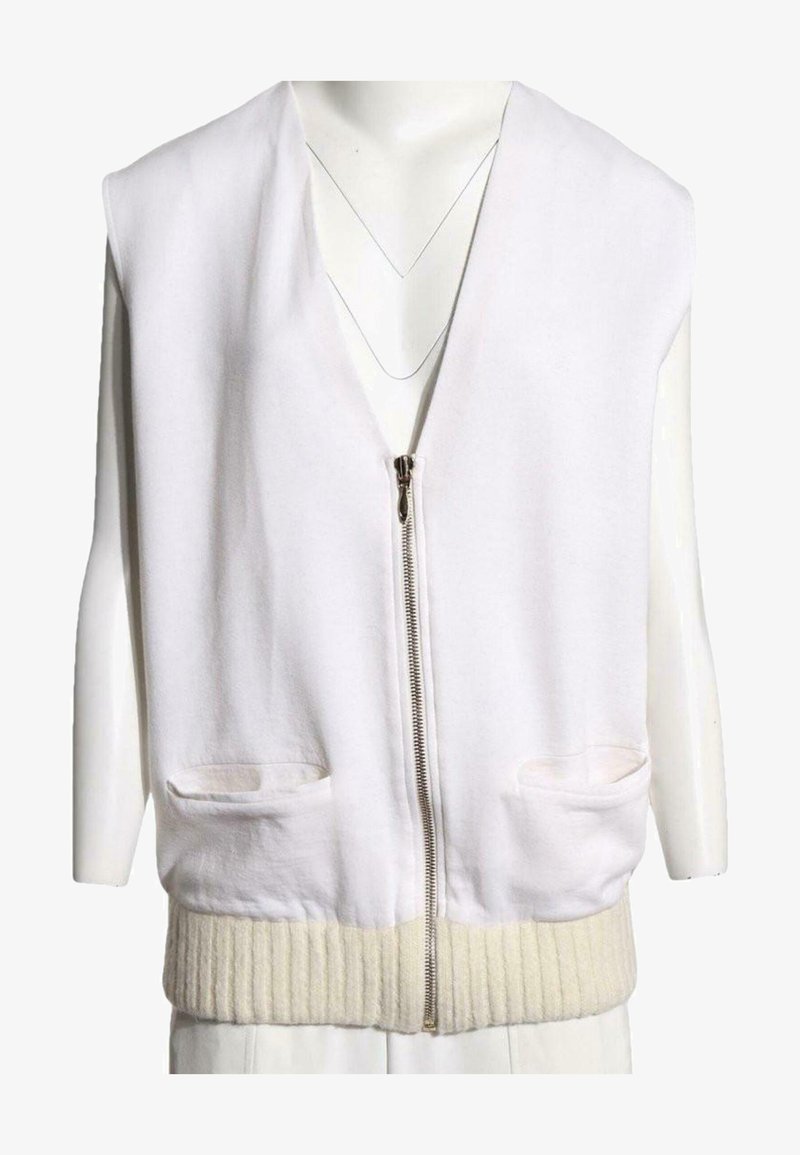 Veste blanche sans manches avec fermeture éclair, deux poches frontales et un ourlet en maille côtelée, présentée sur un mannequin.