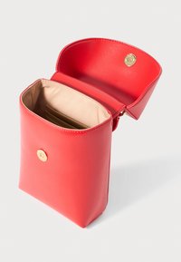 Red leather crossbody bag with beige fabric interior, gold magnetic snap closure, and internal card slots, shown open on white background.