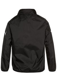 Black jacket made of lightweight fabric with a collar. Features elastic cuffs and a subtle textured pattern. Logo on the left sleeve.