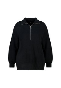 Zwart gebreide trui met een hoge kraag en een halve rits. Heeft brede mouwen en een losse pasvorm. De stof is overal textuurrijk.