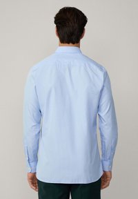 Light blue, long-sleeve button-up shirt featuring a subtle striped pattern, a classic collar, and buttoned cuffs. Back view displayed.