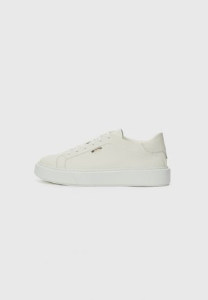 Low-top white sneaker with lace-up design, textured side panel, and thick sole shown in side profile on plain background.