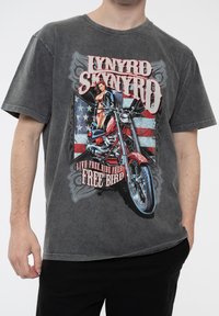 Charcoal grey cotton t-shirt featuring a large graphic of a motorcycle and a woman against a partially American flag background.