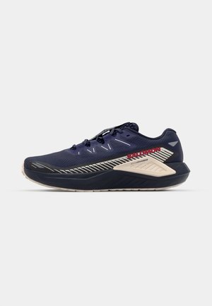 Navy running shoe with mesh upper, textured pattern, light gray and red accents, and thick cushioned sole for support and comfort.