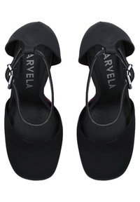 Black slingback shoes with a rounded toe, smooth fabric exterior, and a textured insole. Features a buckle strap for secure fastening.