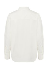 Vista posteriore di una camicia bianca semplice con maniche lunghe, polsini abbottonati e colletto dritto.
