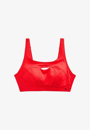 Red sports bra with a small front cutout and wide shoulder straps, designed for support and comfort during physical activity.