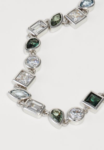 Brăţară din metal cu finisaj argintiu, prezentând o serie de pietre preţioase de diverse forme în nuanţe de verde, albastru şi transparent, conectate prin mici elemente de legătură din argint.