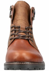 Brown leather boot with a rounded toe, brown laces, and metal accents. Textured upper and a black rubber sole with tread pattern.