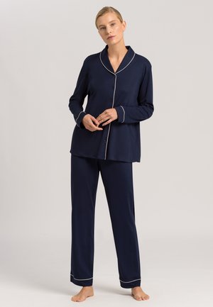 Navy blue pajama set featuring a button-up top with a collar and white piping, paired with straight-leg pants. Soft fabric with a relaxed fit.