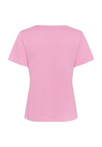 Rövidujjú világos rózsaszín pamut póló, kerek nyakkivágással és sima textúrával, látható minták vagy díszítések nélkül.