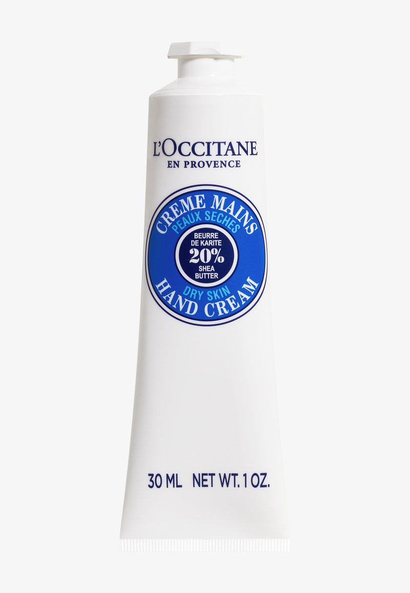 Tuba kremu do rąk L'Occitane, 30 ml, oznaczona "Sucha skóra", zawiera 20% masła shea, przeznaczona do nawilżania i odżywiania rąk.