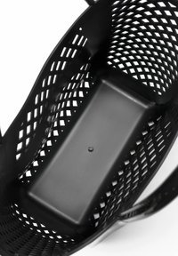 Black woven plastic basket with open grid design, rectangular base, smooth interior, and a small central circular accent.
