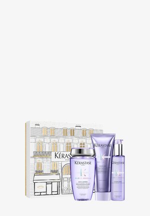 Kérastase Blond Absolu Geschenkeset mit drei lila Flaschen: Shampoo, Conditioner und Serum. Die Box hat ein Design eines Pariser Gebäudes.