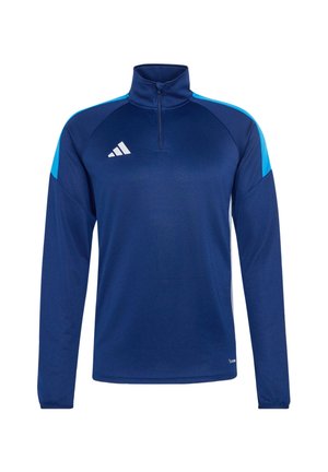 Μακρυμάνικο αθλητικό μπλουζάκι σε ναυτικό μπλε με φερμουάρ στο ένα τέταρτο του μήκους, ανοιχτό μπλε λεπτομέρειες στους ώμους και λευκό γεωμετρικό λογότυπο στο στήθος.