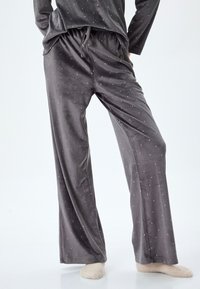 Grauvelours-Pyjama-Hosen mit entspanntem Schnitt, elastischem Bund mit Kordelzug und kleinen weißen Punktakzenten.