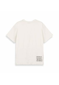 Camiseta de algodón color crema con un corte relajado, mangas cortas y un estampado de texto gráfico negro en la parte inferior derecha. Textura suave, diseño sencillo.