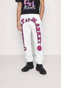 Market CALI ARC PEACE UNISEX - Calças de fato de treino - cream