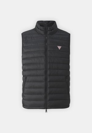 Black padded vest with a high collar, front zip closure, and side pockets. Features a small logo on the upper left. Smooth texture.
