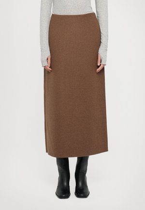 Brown wool maxi skirt with a straight cut, side slit, and a smooth texture, paired with fitted black ankle boots and a gray long-sleeve top.