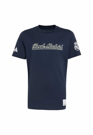 T-shirt in cotone blu navy con "Real Madrid" ricamato in bianco, maniche corte con logo Adidas bianco su un lato e stemma del club sulla manica.