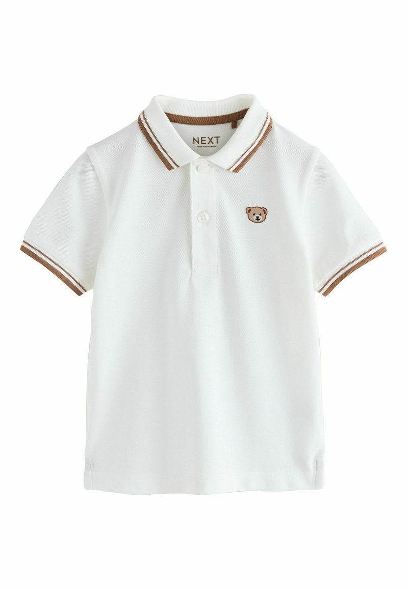 Hvid poloshirt lavet af bomuld med brunstribet krave og ærmekanter. Har et lille broderet bjørnelogo på brystet.