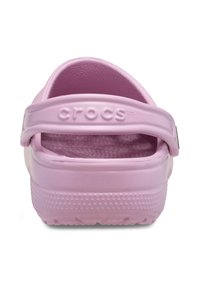 Pink Crocs with a textured material, ventilated design, and a back strap for support. Features raised logo on the strap and a ridged sole.