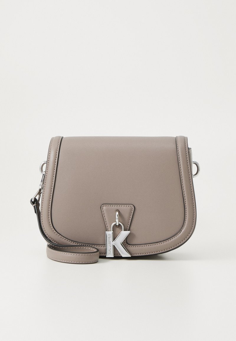 Grey leather crossbody bag with a flap closure, silver hardware, and a prominent letter "K" detail. Featuring an adjustable strap.
