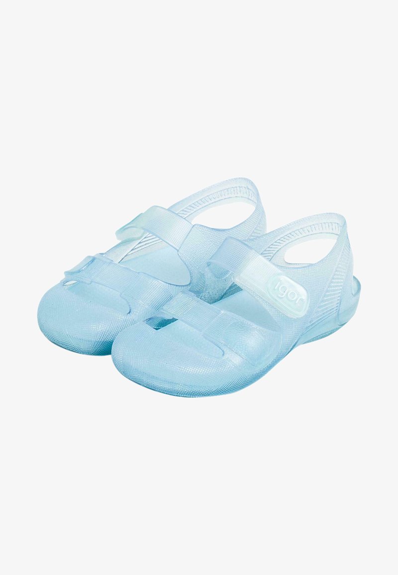 Light blue plastic sandals with adjustable straps, closed toes, and open heels. Smooth texture with a subtle grip pattern on the sole.