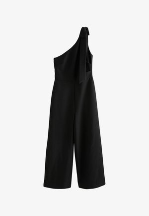 Salopetă neagră cu un singur umăr, pantaloni largi și un detaliu cu nod pe breteaua unică de pe umăr.
