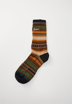 Multicolored socks featuring horizontal stripes in orange, green, gray, and black with ribbed texture and a logo at the top.