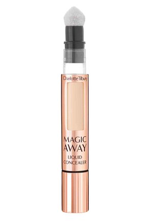 Correcteur liquide dans un tube transparent avec une base en or rose, présentant un embout applicateur doux et rond ainsi qu'une fenêtre de produit visible.