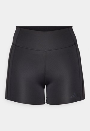 Czarne sportowe szorty wykonane z elastycznego materiału, z wysokim stanem, płaskimi szwami i subtelnym logo Adidas w dolnym rogu.