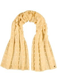 Bufanda de color amarillo claro, hecha de un tejido suave y texturizado. Presenta un patrón de puntos y bordes deshilachados. Tiene una forma rectangular larga para un estilo versátil.