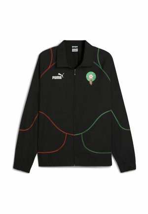 Schwarze Jacke mit Reißverschluss vorne, ausgestattet mit grünen und roten geschwungenen Linien, Puma-Logo auf der linken Brust und marokkanischem Emblem auf der rechten Seite.