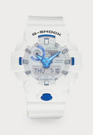 Weiße G-Shock-Uhr mit blauen Akzenten, digitalen und analogen Anzeige, strukturiertem blauen Druckknopf, stoßfesten Eigenschaften und Wasserbeständigkeit.