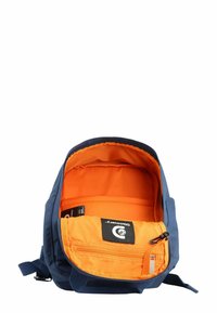 Blue backpack with an orange interior. Features a zippered main compartment and front pocket with a logo patch. Durable fabric, rectangular shape.