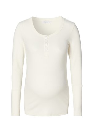 Kremowa koszula z długim rękawem z prążkowanej tkaniny z dekoltem w serek i guzikami z przodu. Charakteryzuje się miękką teksturą i dopasowanym krojem.