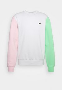 Färgad sweatshirt med vit kropp, rosa vänster ärm och grön höger ärm. Ribbad nederkant och halsringning; liten logotyp på bröstet.