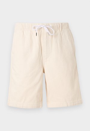 Shorts en coton beige avec une coupe décontractée, une taille élastique et un cordon de serrage blanc. Comprend des poches latérales et une texture lisse.