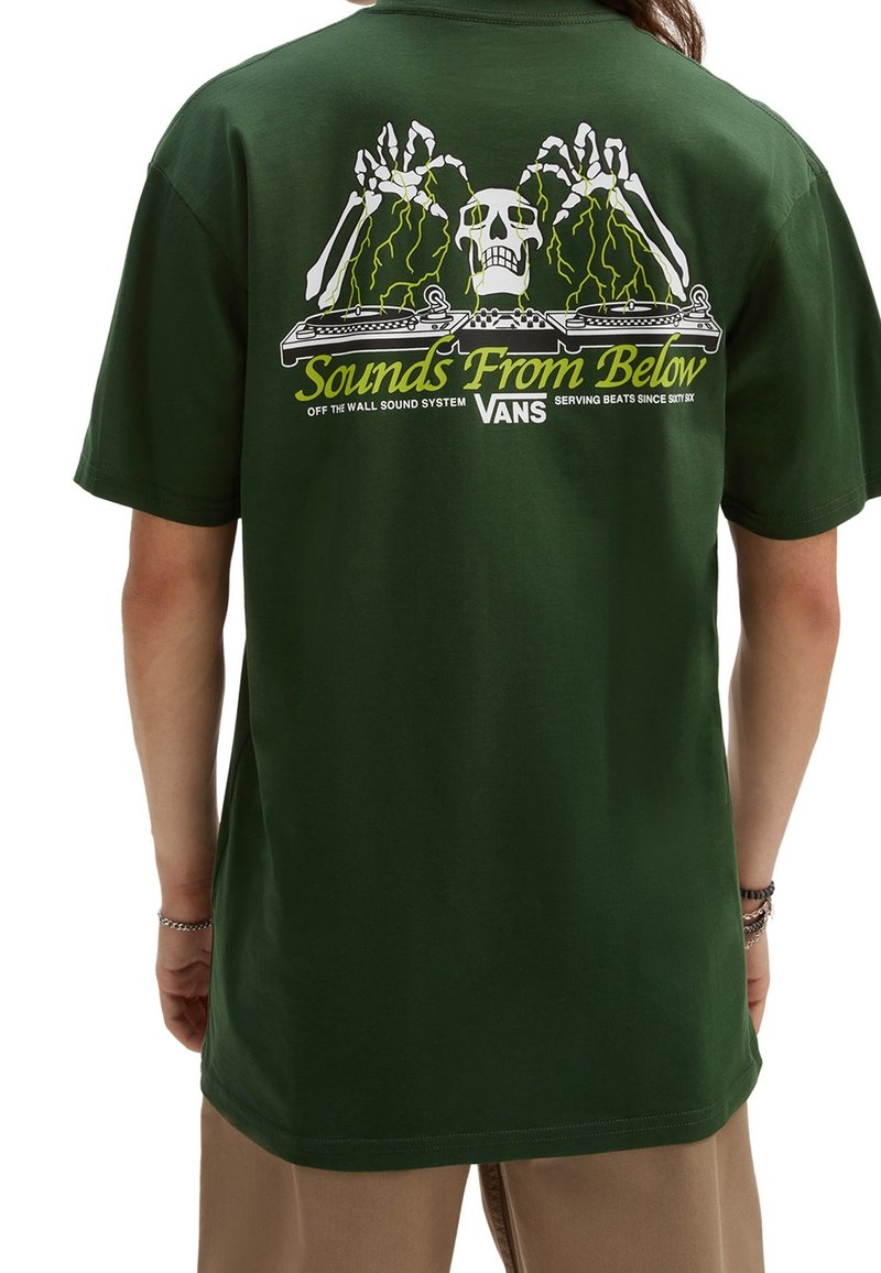 Green cotton t-shirt featuring a graphic of a skull and skeleton hands with turntables, text reading "Sounds From Below," in yellow and white.