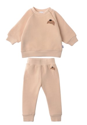 Beiges Sweatshirt- und Hosen-Set aus weichem Stoff. Jedes Teil ist mit einem kleinen Cartoon-Hund-Print versehen. Gerippte Bündchen und Bund.
