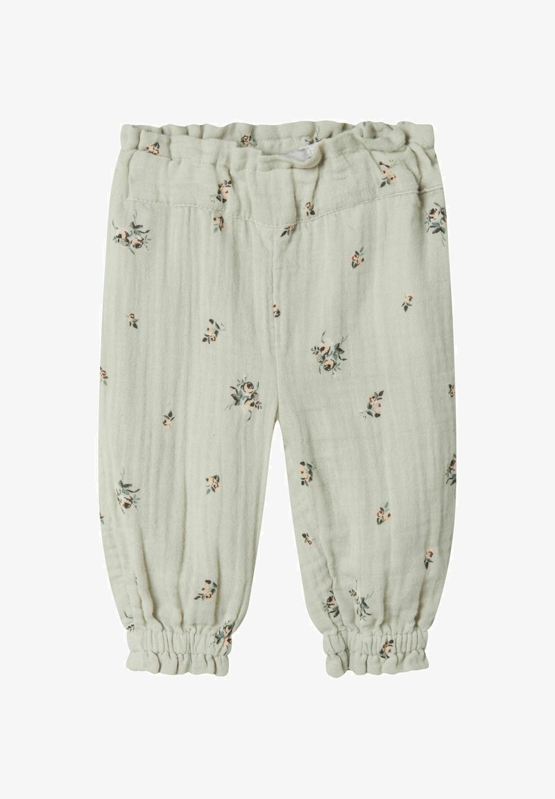 Světlé zelené kalhoty pro batolata vyrobené z jemné látky, s květinovým vzorem v růžové a zelené barvě. Elastický pas a nařasené manžety u kotníků.