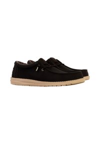 Scarpe casual nere con una texture morbida, design minimalista, punta rotonda e suola in gomma beige con foderatura a motivo e lacci decorativi.