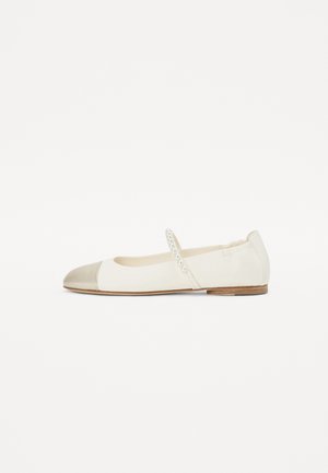 White leather ballet flat with a metallic gold toe cap, elastic strap adorned with small pearls, and a flat wooden sole.