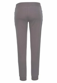 Graue Jogginghose mit einem taillierten Bund, schmal zulaufenden Beinen und seitlichen Taschen mit einem dezenten, gemusterten Besatz. Weicher Stoff. 