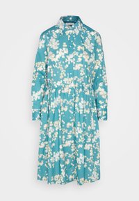 Turkos klänning med vitt blommönster, knappstängning fram, långa ärmar och rynkad midja. Tillverkad av lättviktig tyg.