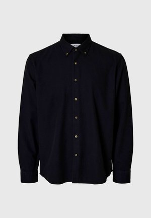 Tamsiai mėlyna marškinėlių palaidinė, ilgomis rankovėmis, klasikinis apykaklė, metalinės sagos, lygus audinio tekstūra, tiesus kraštas. Be raštų ar akcentų.