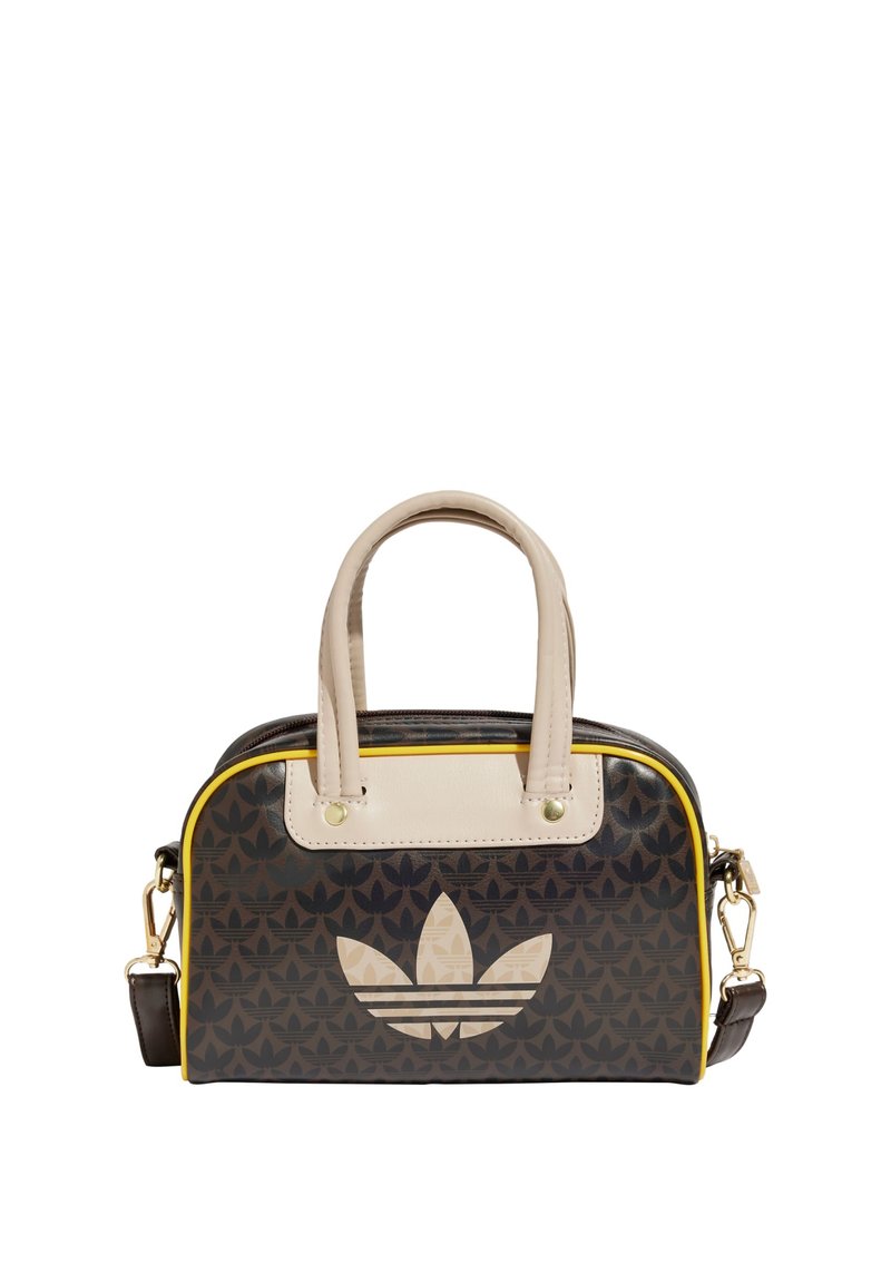 Svart mönstrad handväska med krämfärgade accenter, övre handtag och avtagbar rem. Har en framträdande beige Adidas-logotyp på framsidan.